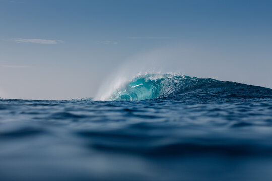 View of a giant wave crashing in the distant coastline of Lanzarote