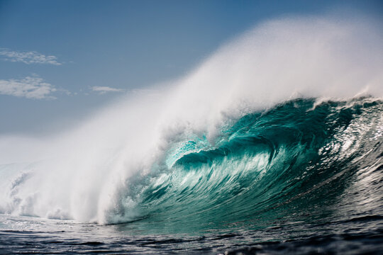 Panoramic view captures a massive wave crashing in the open ocean