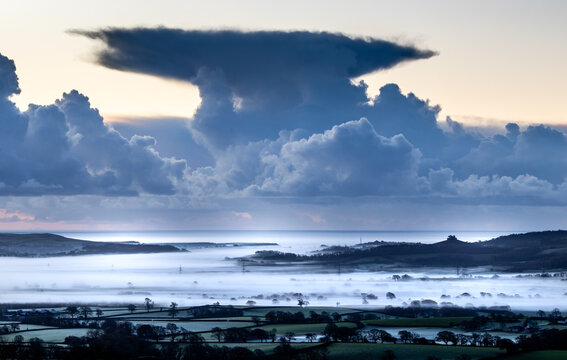 Thundercloud above a coastal mist valley