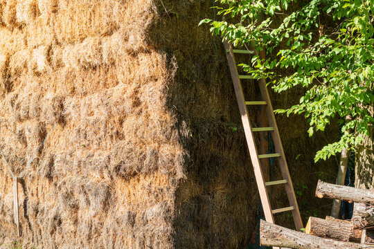 Rustic Hay Stack with Ladder in Sunlit Countryside