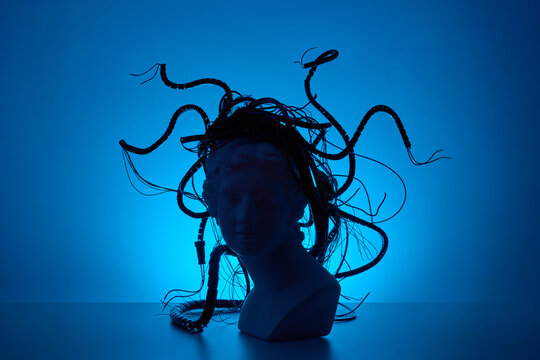 Blue neon Medusa silhouette with cyber cables