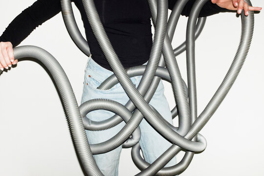 Person holding cleaning hoover vacuum cleaner with direct flashlight