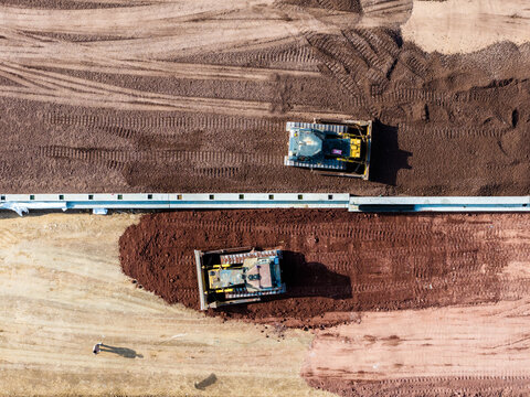 Aerial bulldozer earth leveling construction site