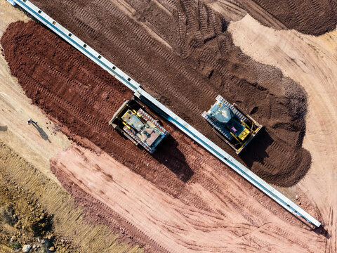 Aerial bulldozer earth leveling construction site