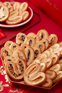 Homemade butterfly cookies on a red table，closeup 
