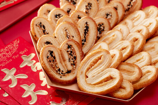 Homemade butterfly cookies on a red table，closeup 