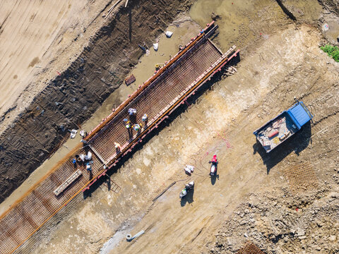 Aerial View of Workers Building Concrete Foundation