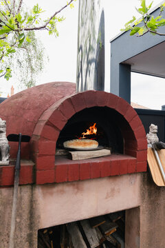 Outdoor oven with fire baking Bread  