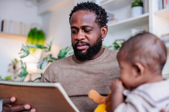 Father reading with baby.