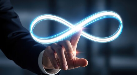 Businessman hand touching a glowing infinity loop to represent endless possibilities and continuous business improvement.