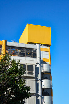 Bright Yellow Blank Box for Branding Against a Blue Sky. 