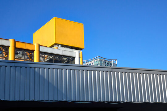 Bright Yellow Blank Box for Branding Against a Blue Sky. 