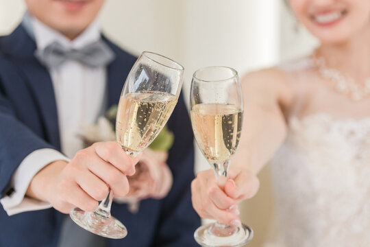 Bride and groom toasting at wedding ceremony (champagne, alcohol, drinking)
