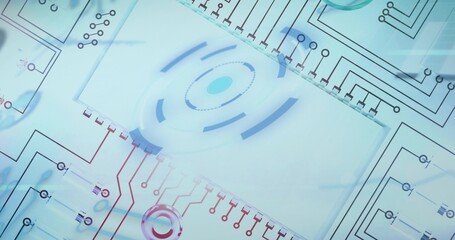 Fototapeta premium Displaying central translucent panel showing concentric rings and circuit traces in studio flatlay