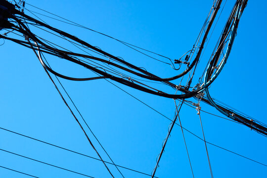 Many Electrical Wires and Cables Against Clear Blue Sky