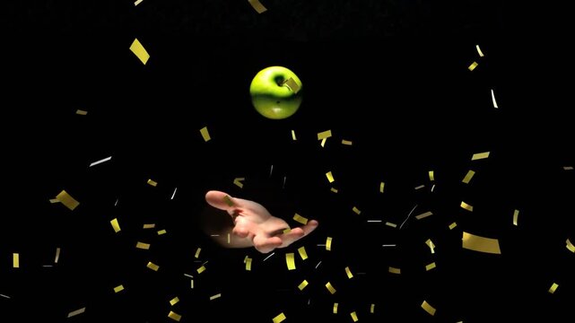 Dark backdrop starting hand entry apple hovering over palm as gold confetti falling marking reveal