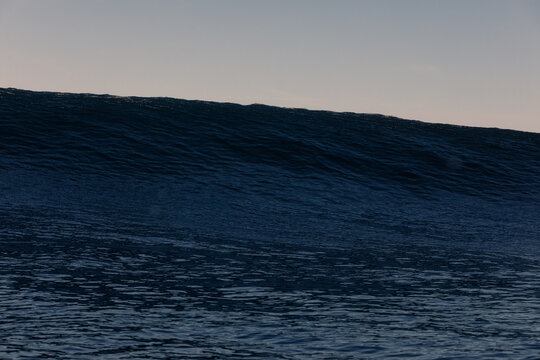 A huge wave beginning to form in the middle of the open sea