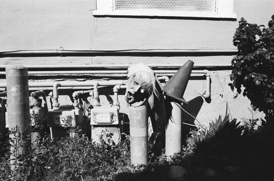 Black and White Film Image of a Halloween Mask and a Utility Cone 