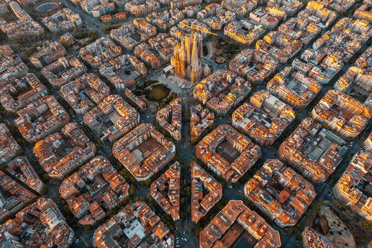 Aerial view of Barcelona skyline at sunrise with Eixample grid and Sagrada Familia