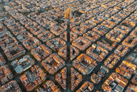 Aerial view of Barcelona skyline at sunrise with Eixample grid and Sagrada Familia