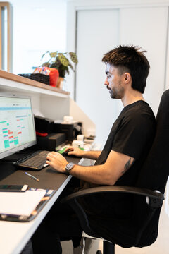 Man working on computer at veterinary hospital reception desk
