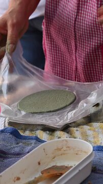 Mexican food, preparing corn memelas on a rustic kitchen