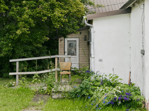 Abandoned Rural Porch with Overgrown Plants