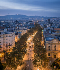 Fototapeta premium Las Ramblas street in Barcelona illuminated at blue hour, Spain