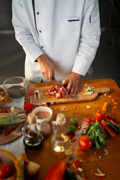 Chef chops food in kitchen
