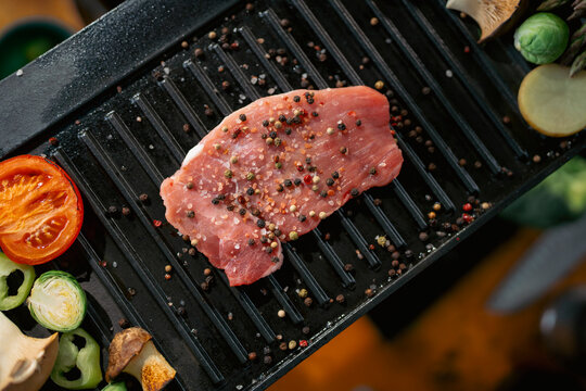 Cooking meat on a grill plate
