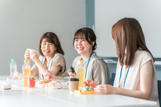 Businesswoman having lunch in the company cafeteria/break room