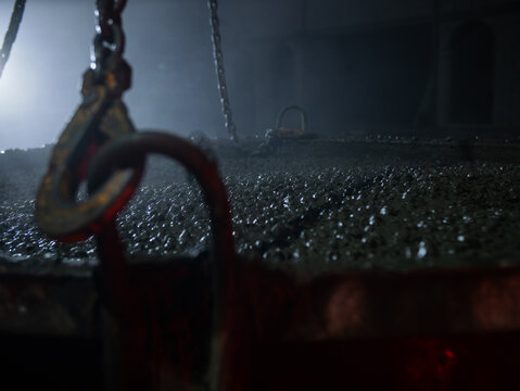 Wet concrete surface with crane chains