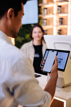 Customer paying with phone at Ocha POS system.