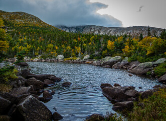 Chimney Pond trail hike at Baxter State Park, Maine, with peak fall foliage on an overcast cloudy day