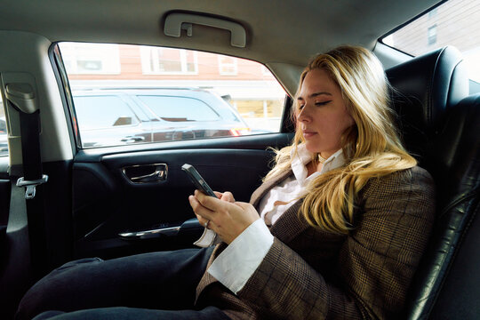 business woman on a backseat uber car