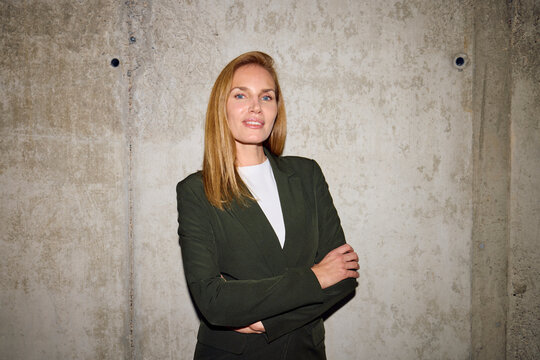 Blonde businesswoman smiles at the camera