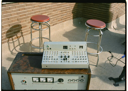 Analog audio mixer, placed next to some benches