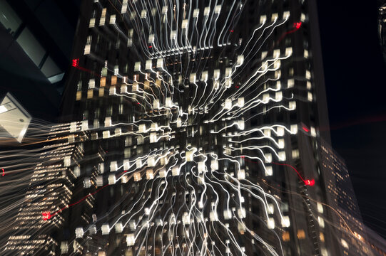 Nighttime Skyscraper with Radiating Light Trails