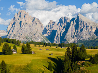 Aerial view of the Alpe di Siusi plateau showcasing expansive alpine pastures framed by Sassolungo and Sassopiatto. The scale and harmony of land and mountains create a timeless Dolomites landscape © Vgallery