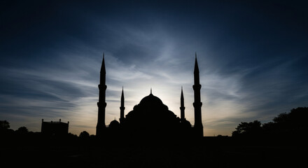 Dramatic silhouette of a majestic mosque with multiple minarets and domes against a serene twilight sky. mosque, silhouette, islamic, architecture, twilight