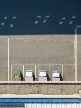 Aerial View of Factory Trucks and Solar Panels on Roof