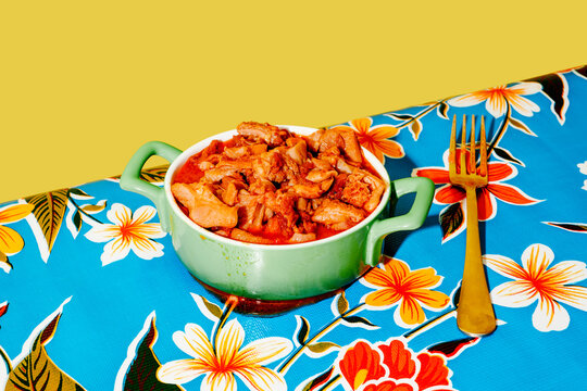a bowl of callos con jamon on a colorful table