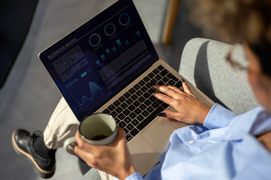 Woman analyzing business model data on laptop