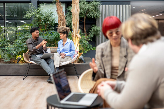 Business colleagues collaborating in a green modern office space