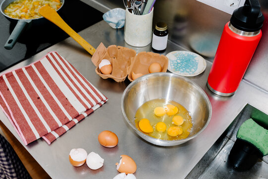 Cluttered kitchen surface with cooking tools used for making eggs
