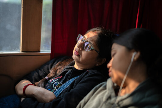 Mother and daughter taking nap while travelling