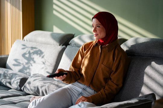 Woman Watching Television at Home in Daylight