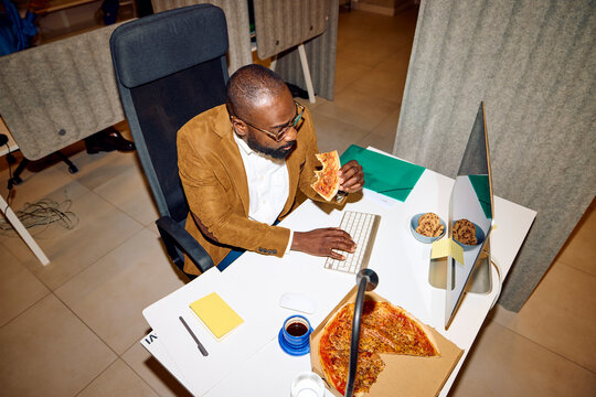 Man eats and works simultaneously