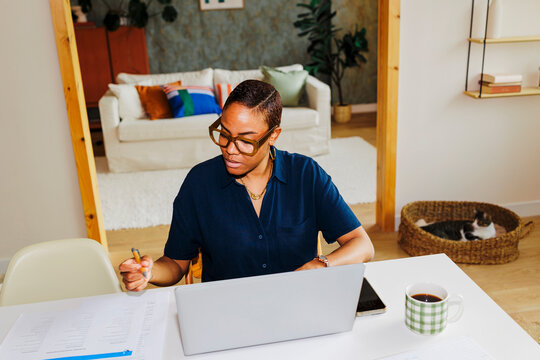 Woman working from home using laptop