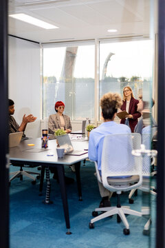 Diverse business team collaborating during conference room meeting
